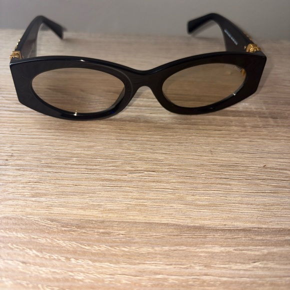 Miu Miu Black Sunglasses with Gold Detailing